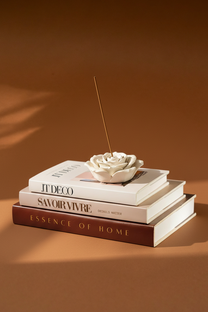 Rose incense holder on coffee table books