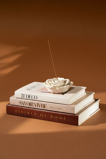 Rose incense holder on coffee table books